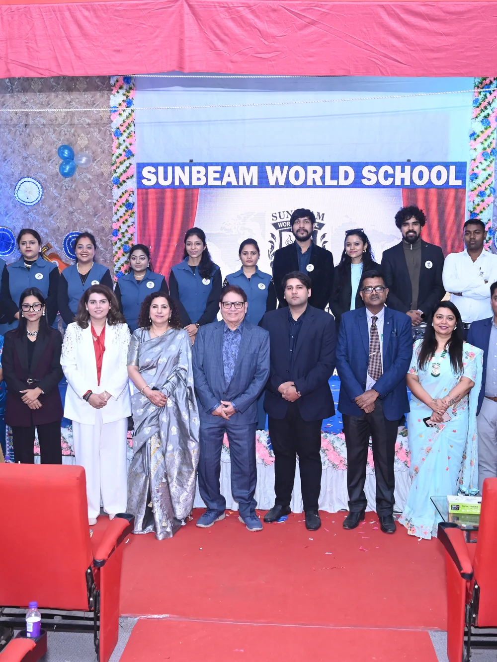 Leadership and staff team on stage at a Sunbeam World School event, Varanasi
