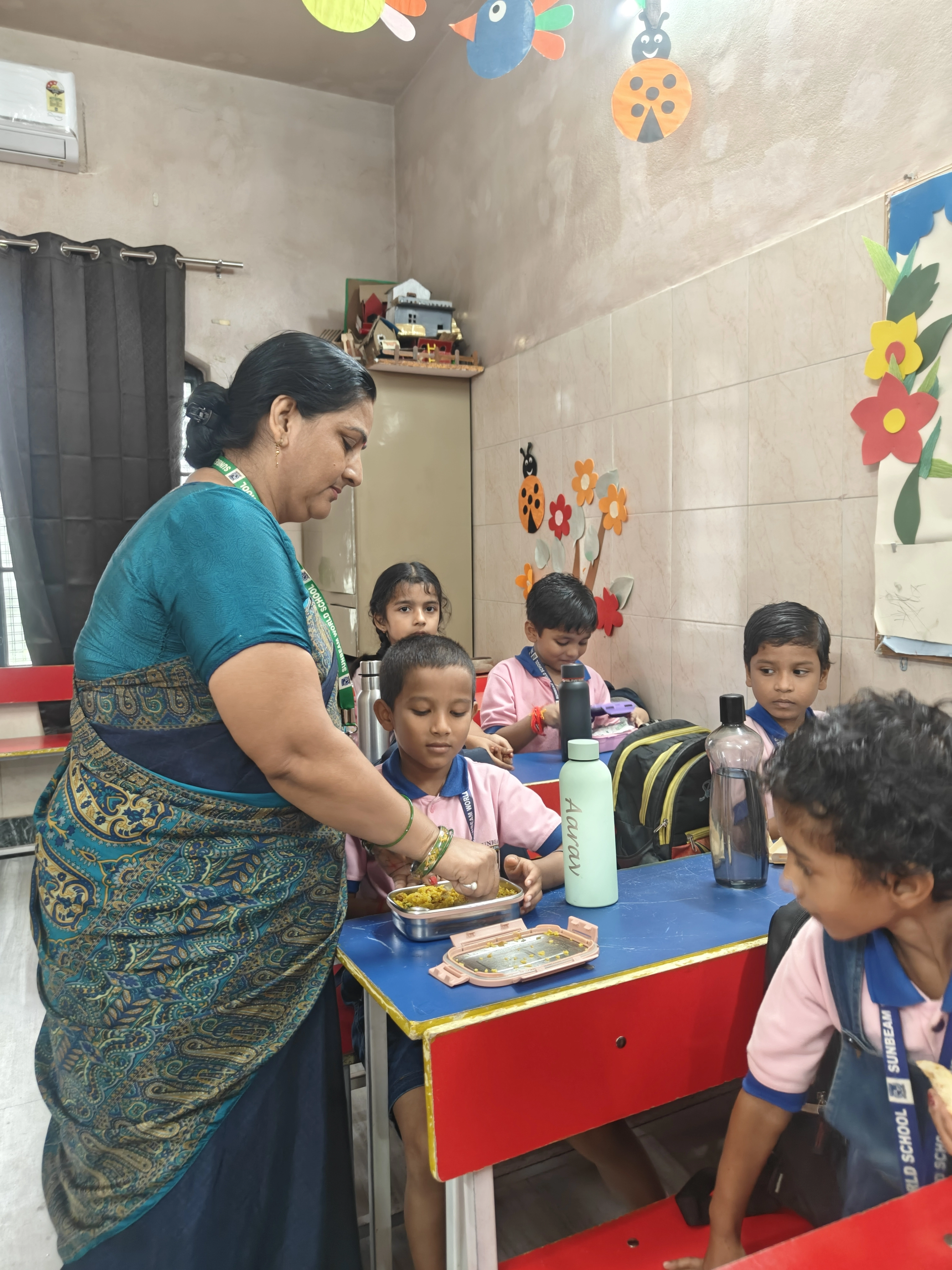 Staff supporting parents and students at a school health check-up camp at Sunbeam World School, Varanasi