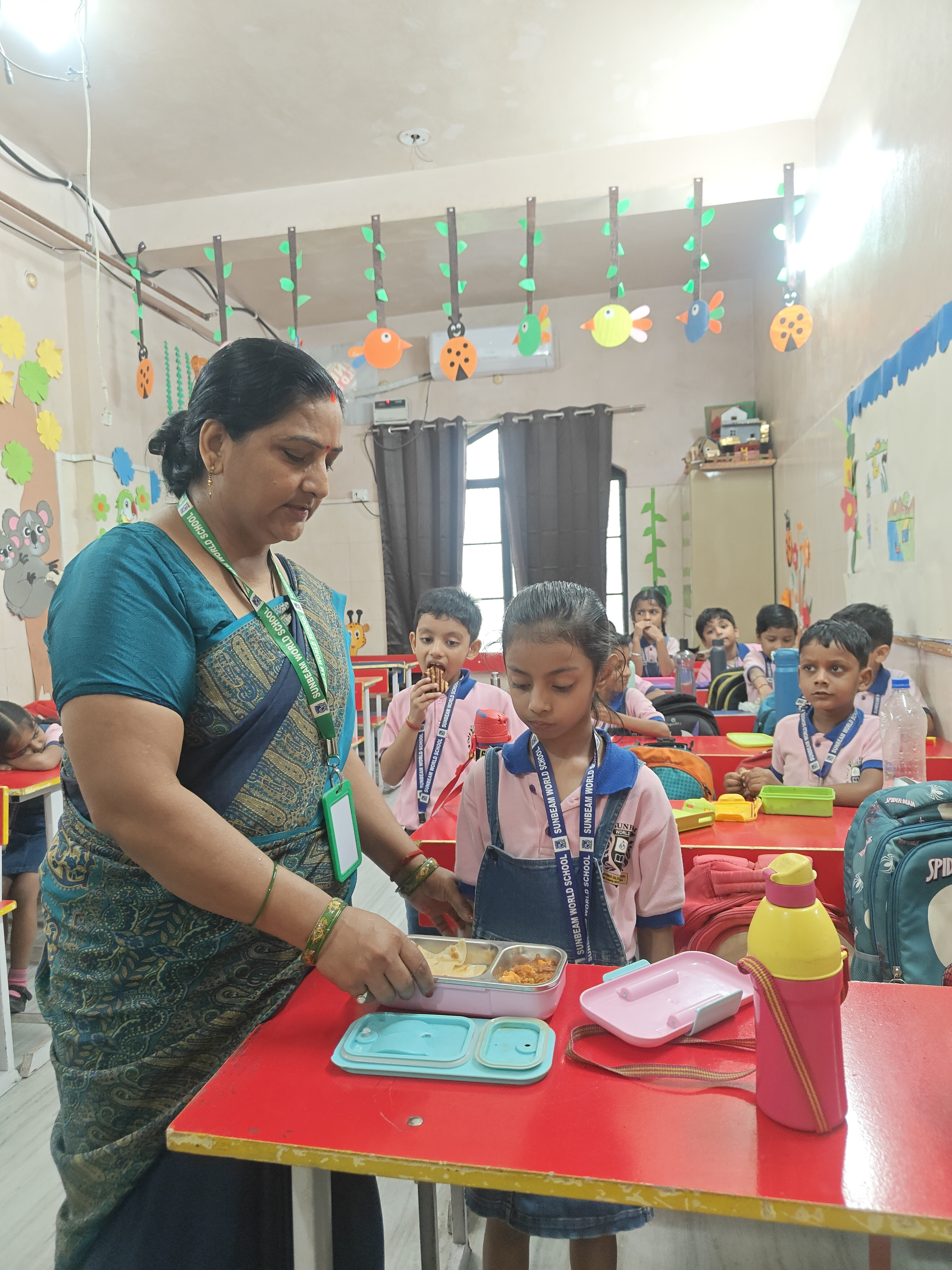 Staff supporting a student during a pottery activity at Sunbeam World School, Varanasi